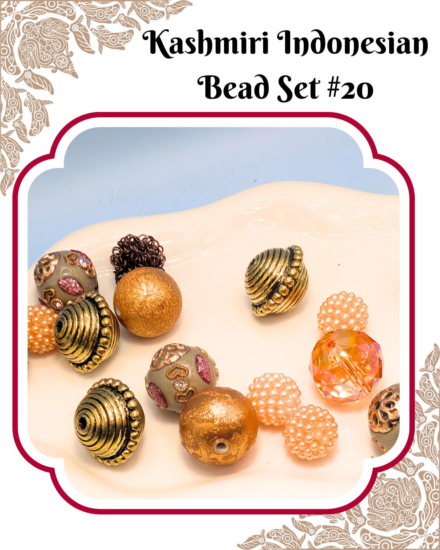 A collection of colorful beads, including gold, silver, and pearl-like beads, arranged on a white surface.