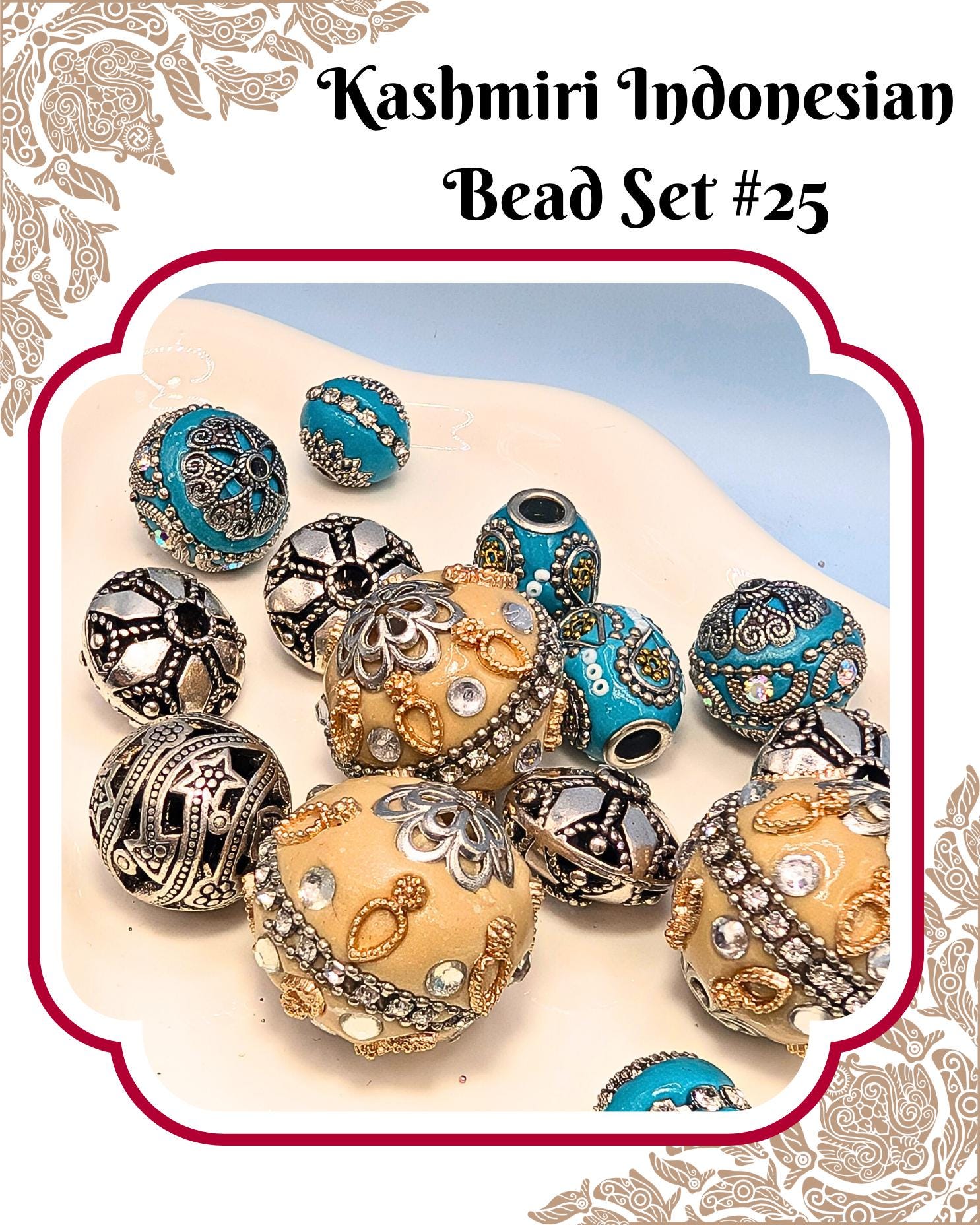 A collection of ornate, colorful beads in various shapes and sizes, including blue, gold, and silver designs, arranged on a white surface.