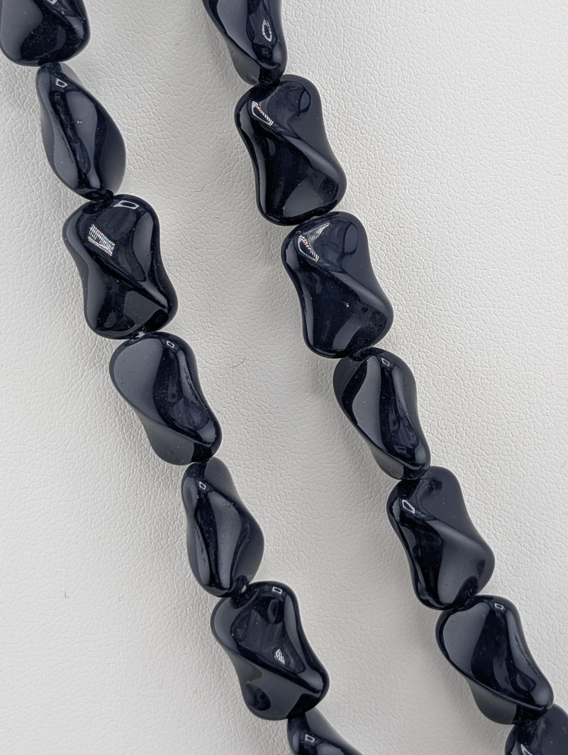 A necklace made of black, irregularly shaped beads.