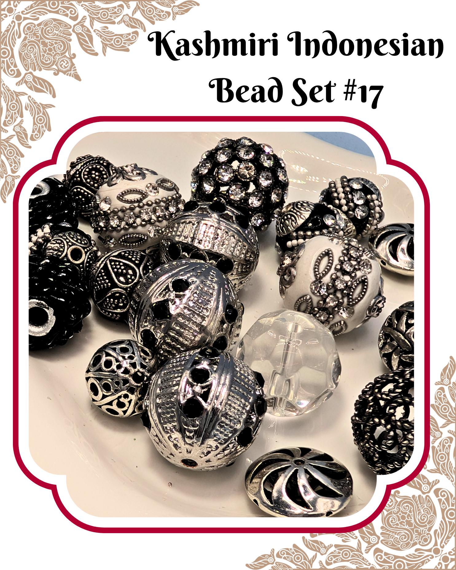 a collection of various beads and jewelry pieces, including clear beads and black and silver beads with intricate designs.