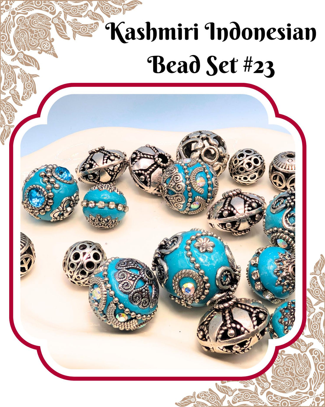 a collection of ornate, blue and silver beads arranged on a white surface.