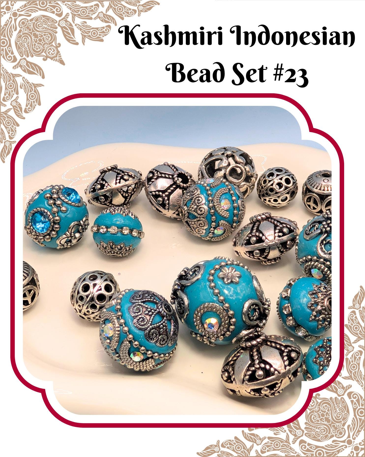 A collection of intricately designed blue and silver beads, including various shapes and patterns, arranged on a white surface.