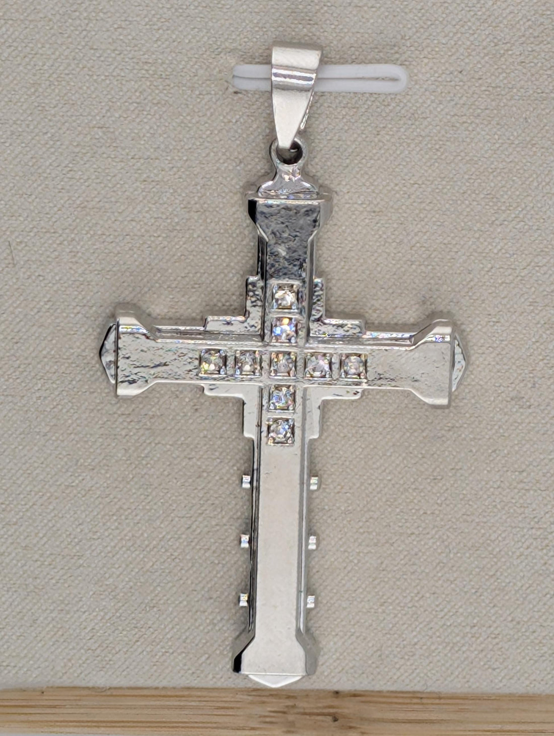 a collection of ornate crosses, each adorned with a sparkling crystal or gemstone. The crosses are arranged in a row, showcasing their intricate designs and the vibrant colors of the gemstones.