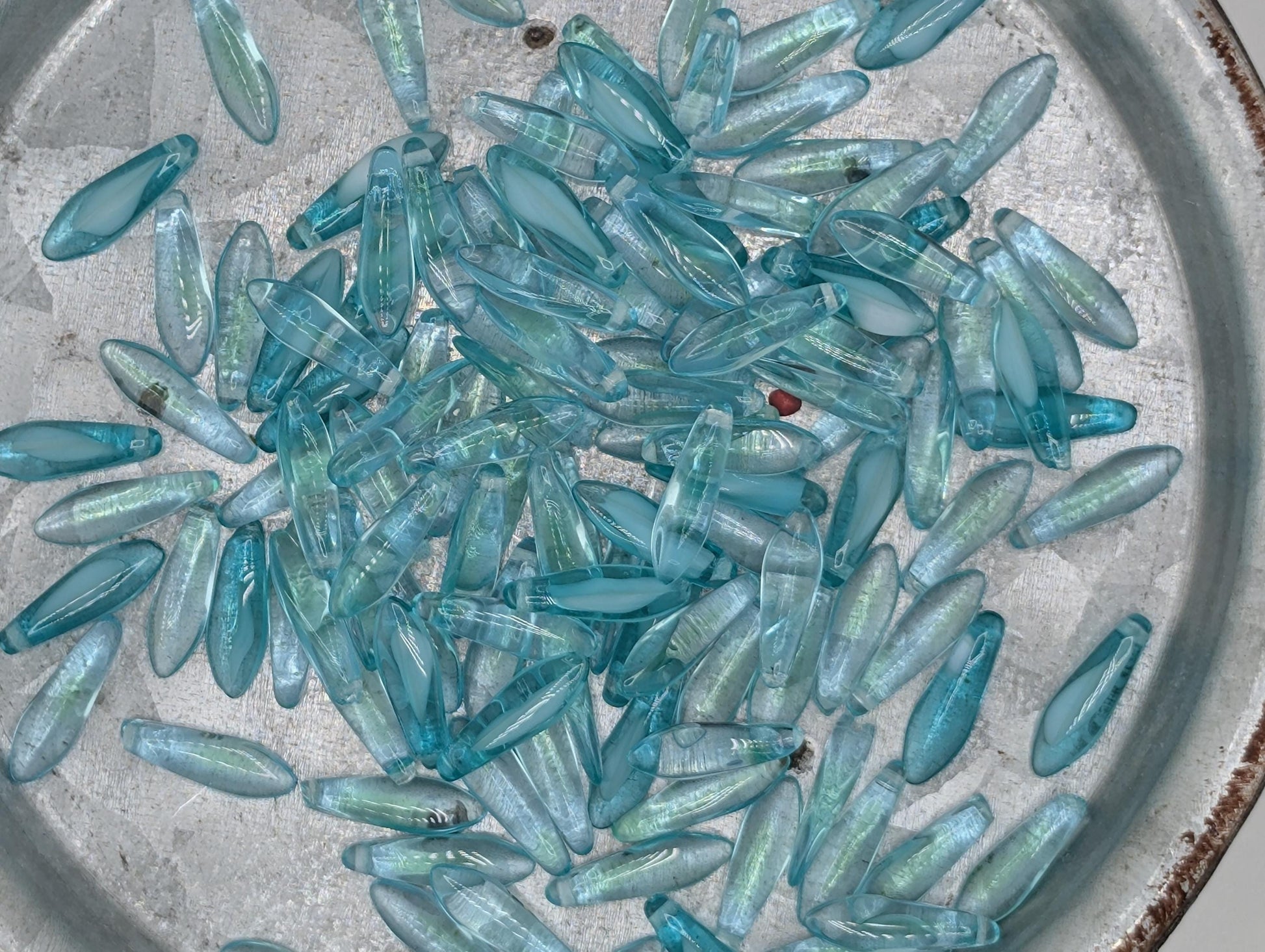 a collection of small, clear glass beads scattered on a surface.