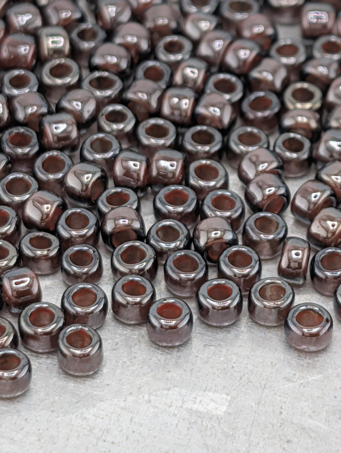 a large number of brown glass beads scattered across a surface.