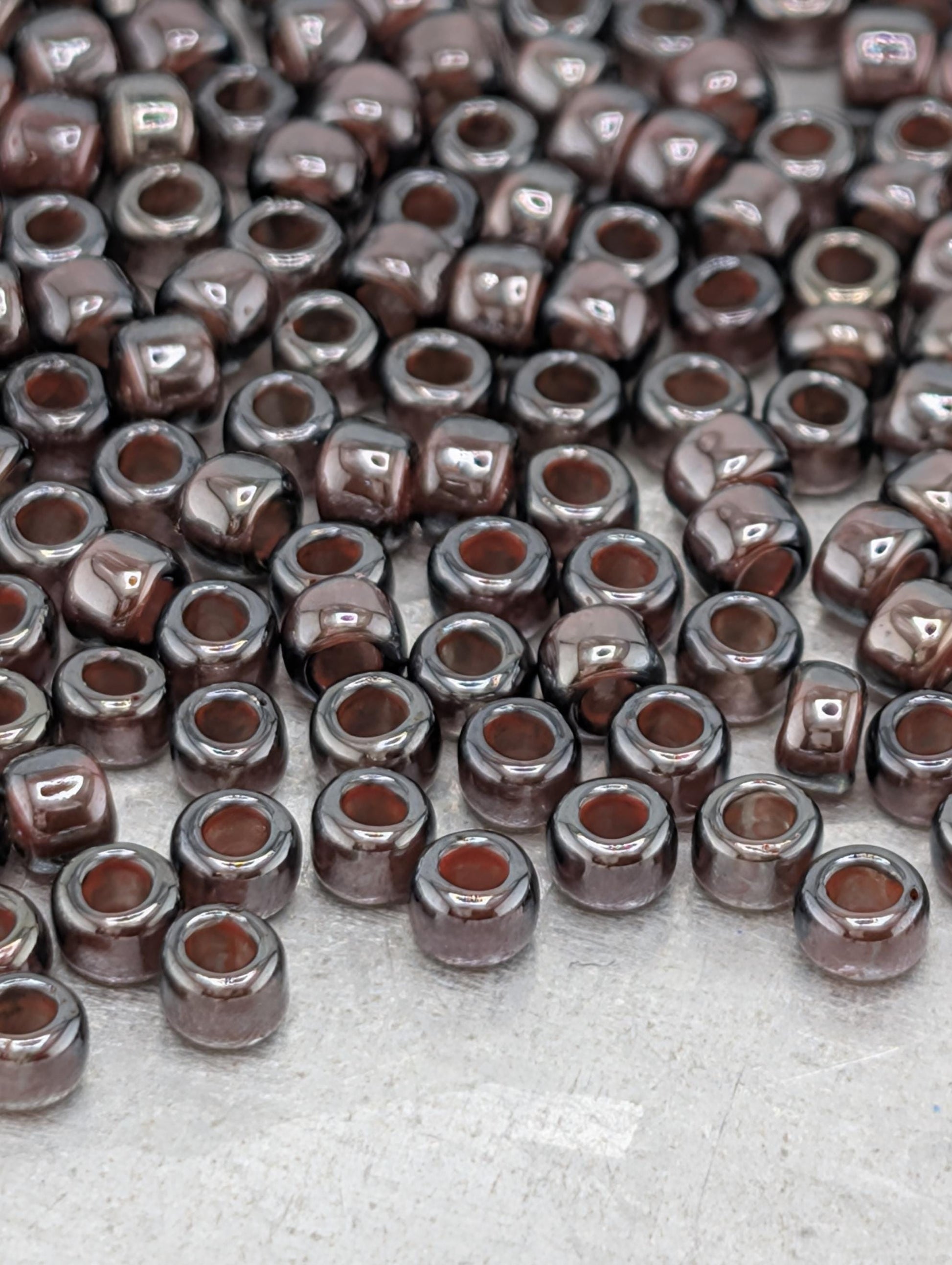 a large number of brown glass beads scattered across a surface.