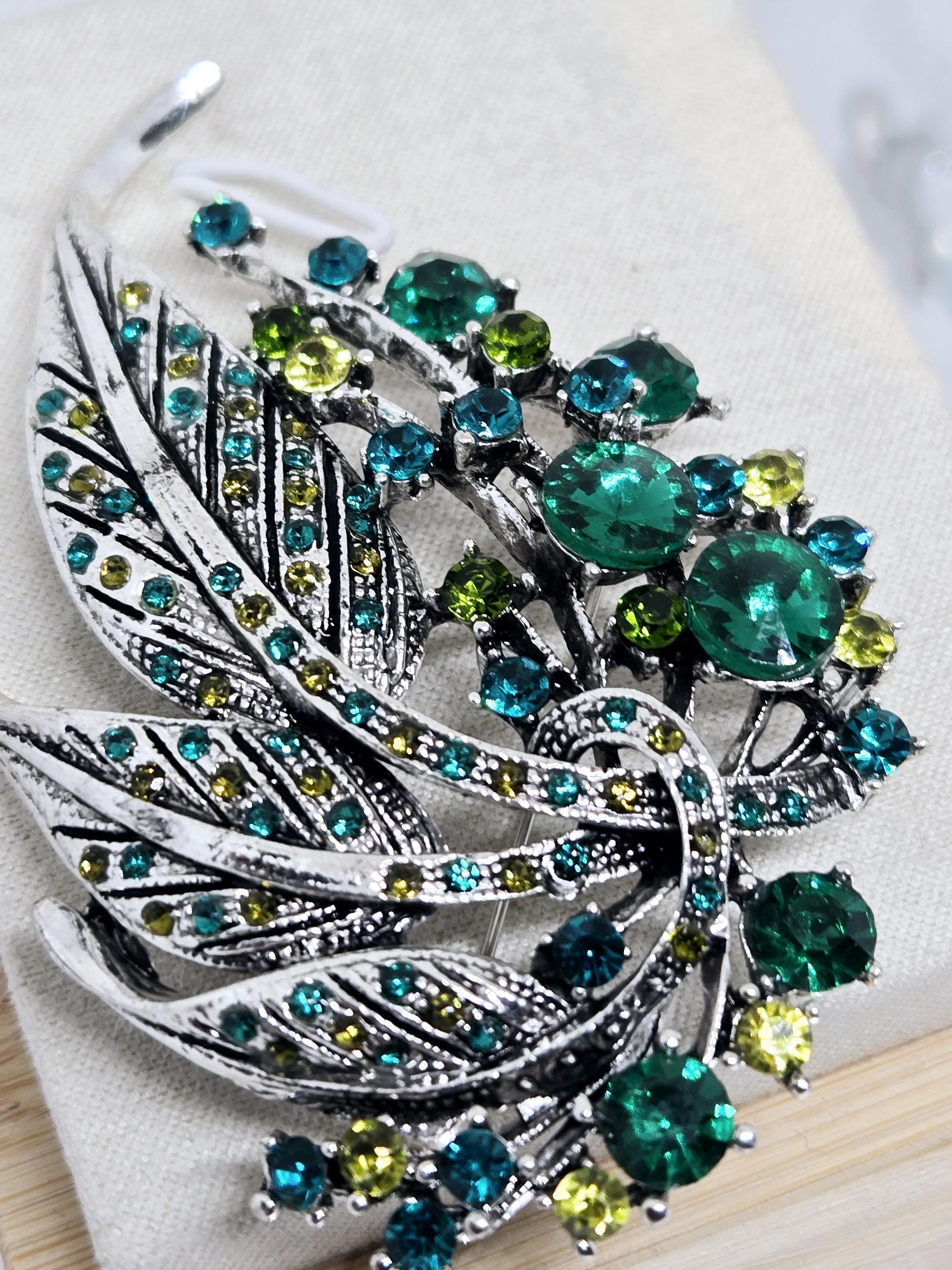 Silver Feather Brooch: Blue Topaz and Emerald Accents