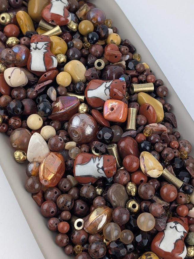 a variety of colorful beads and beads in different shapes and sizes, arranged in a pile or container.