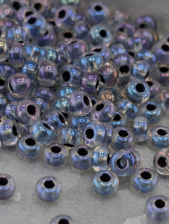 a collection of clear beads scattered on a surface, with some of the beads overlapping each other.