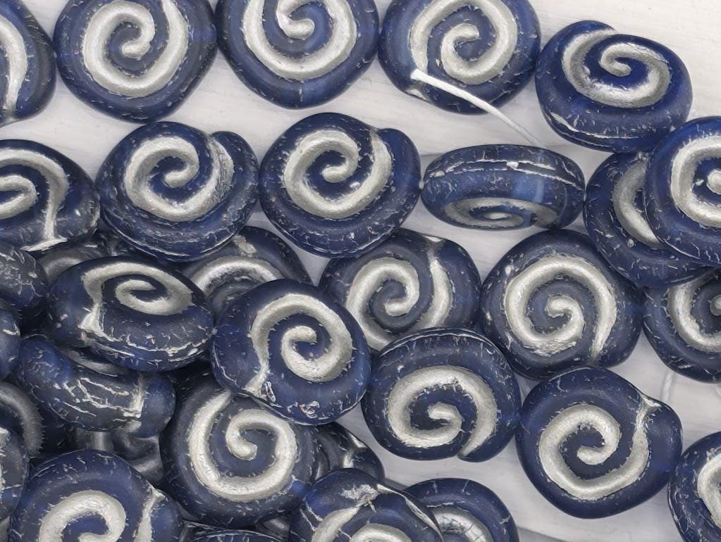 a collection of blue and white spiral beads arranged in a pattern.