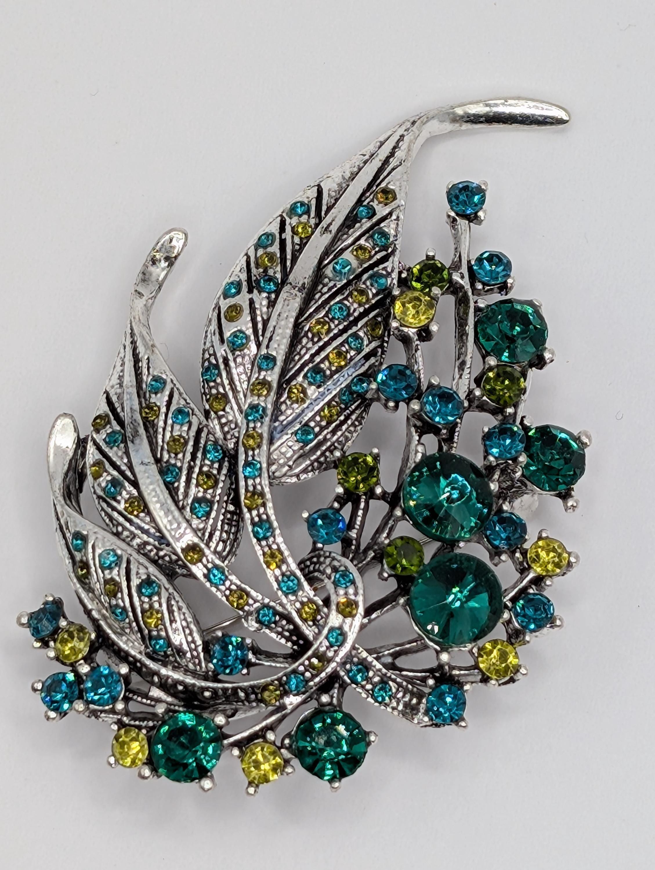 Silver Feather Brooch: Blue Topaz and Emerald Accents