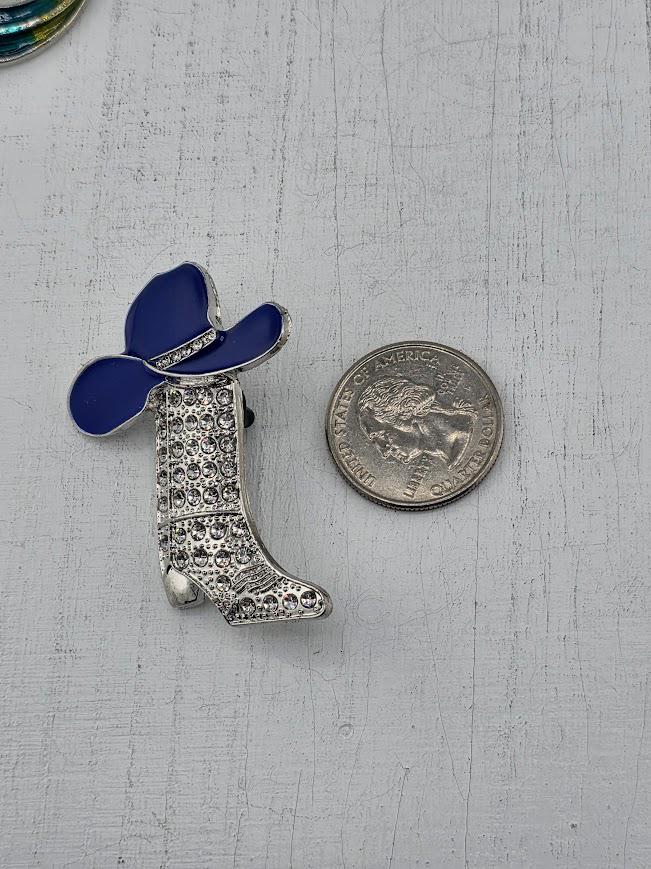 A decorative silver frame with a blue cowboy hat and silver boot embellished with rhinestones.