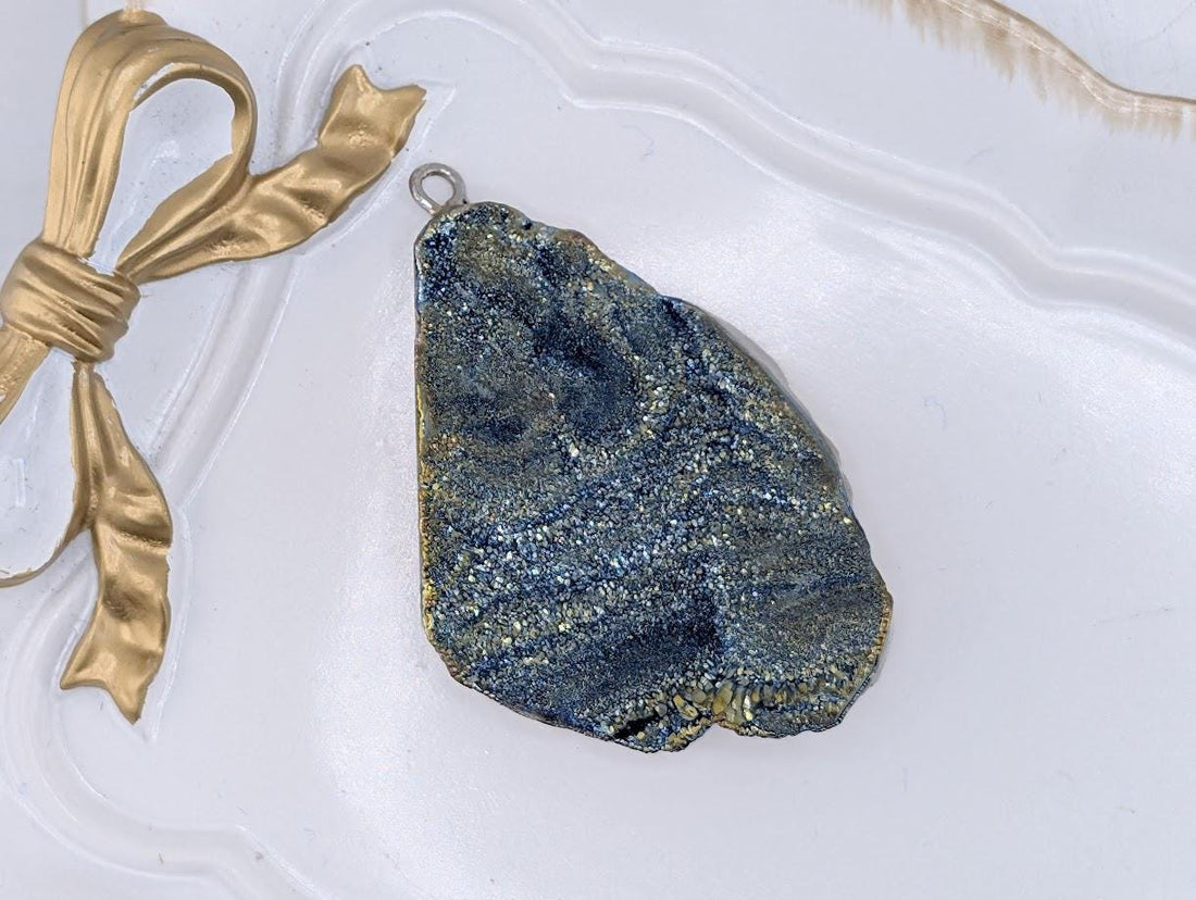 a large, irregularly shaped rock with a blue and gold color pattern, resting on a white surface.