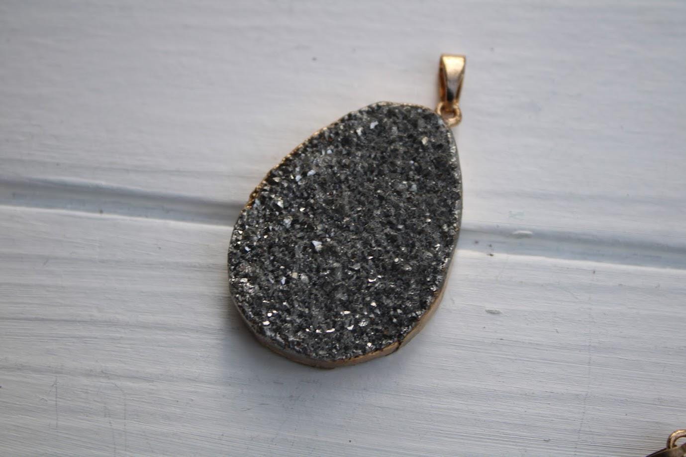 A close-up image of a large, irregularly shaped piece of rock with a rough, speckled surface, resting on a white surface.