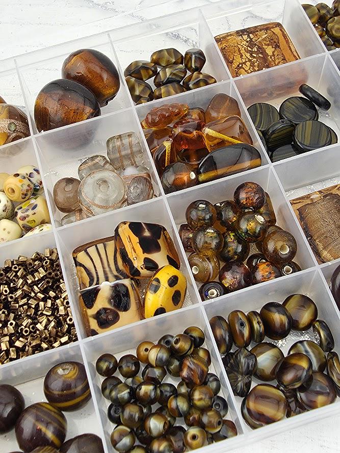 A collection of various beads and beads in different shapes and sizes, organized in multiple compartments.