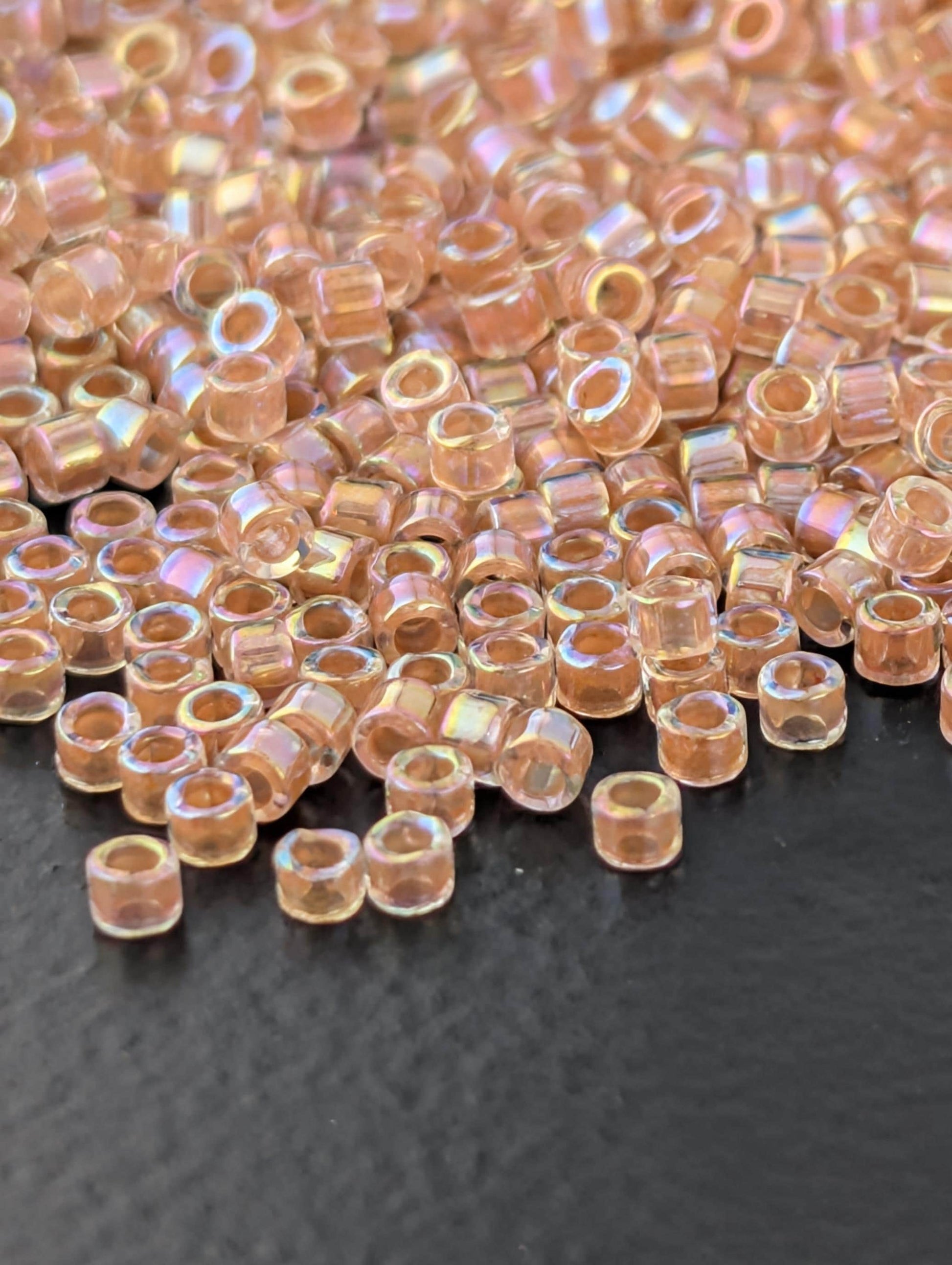DB0054:Crystal/Peachy Gold Inside Color Lined Rainbow Miyuki Delica (Size 11, 7 grams, ~1400 beads)