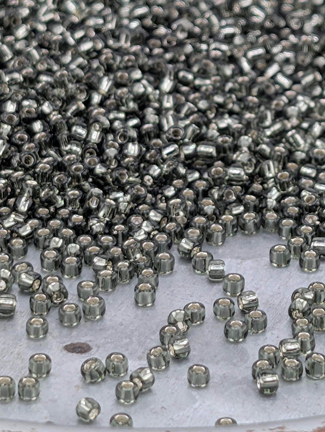 Matsuno Seed Beads: Transparent Gunmetal Silver-Lined - Size 11/0 Round