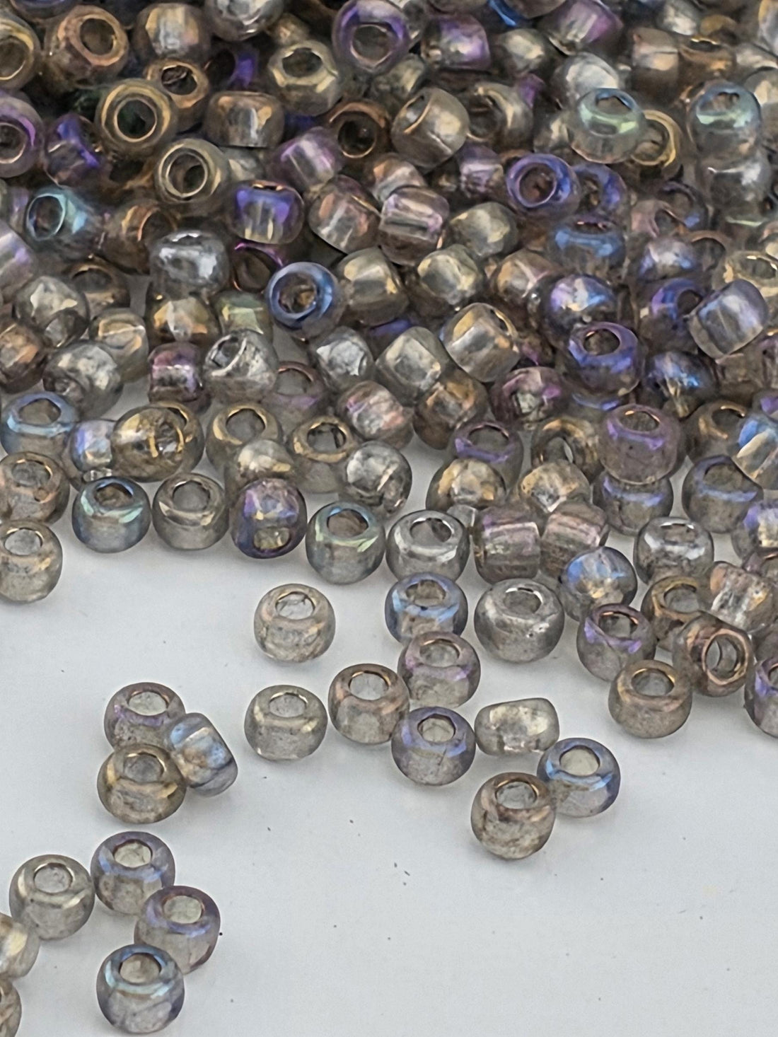 a collection of small, clear beads scattered on a white surface.