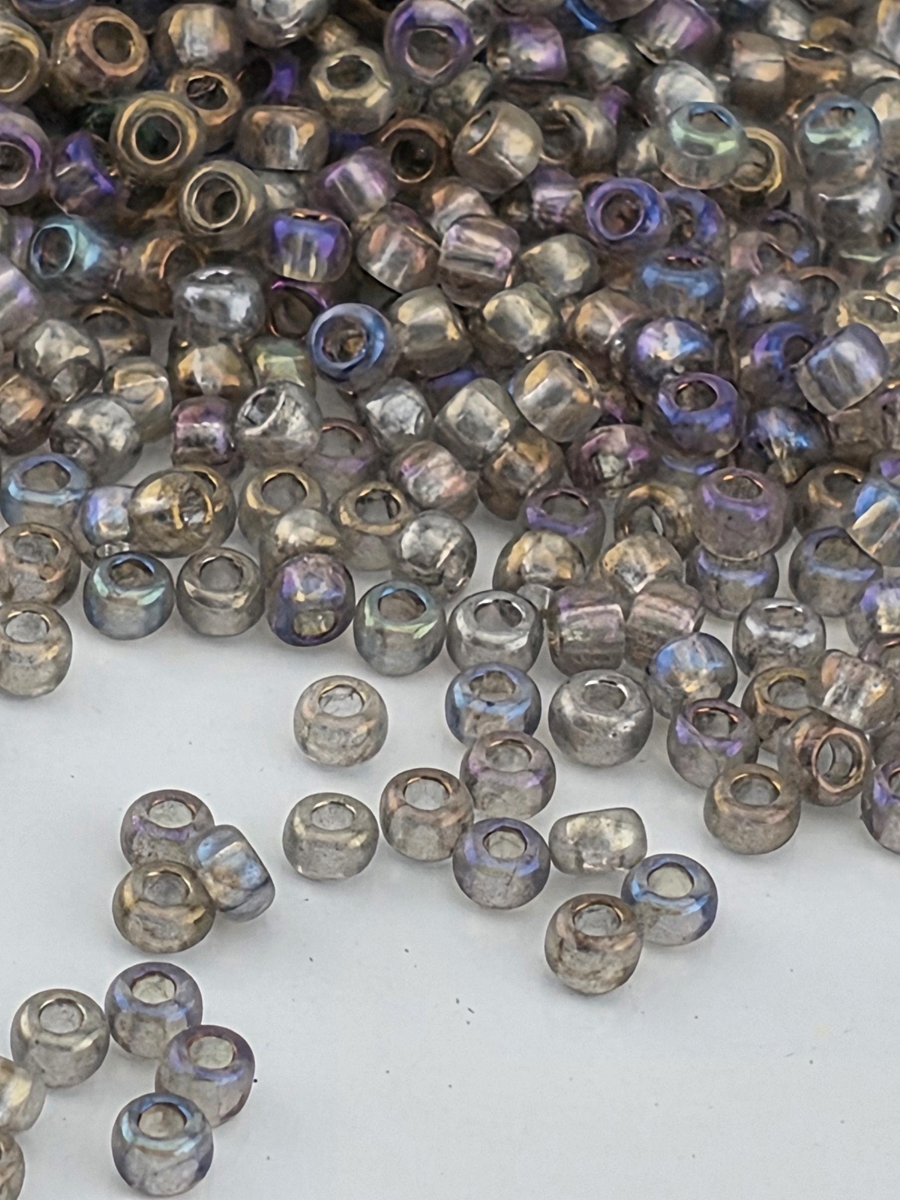 a collection of small, clear beads scattered on a white surface.