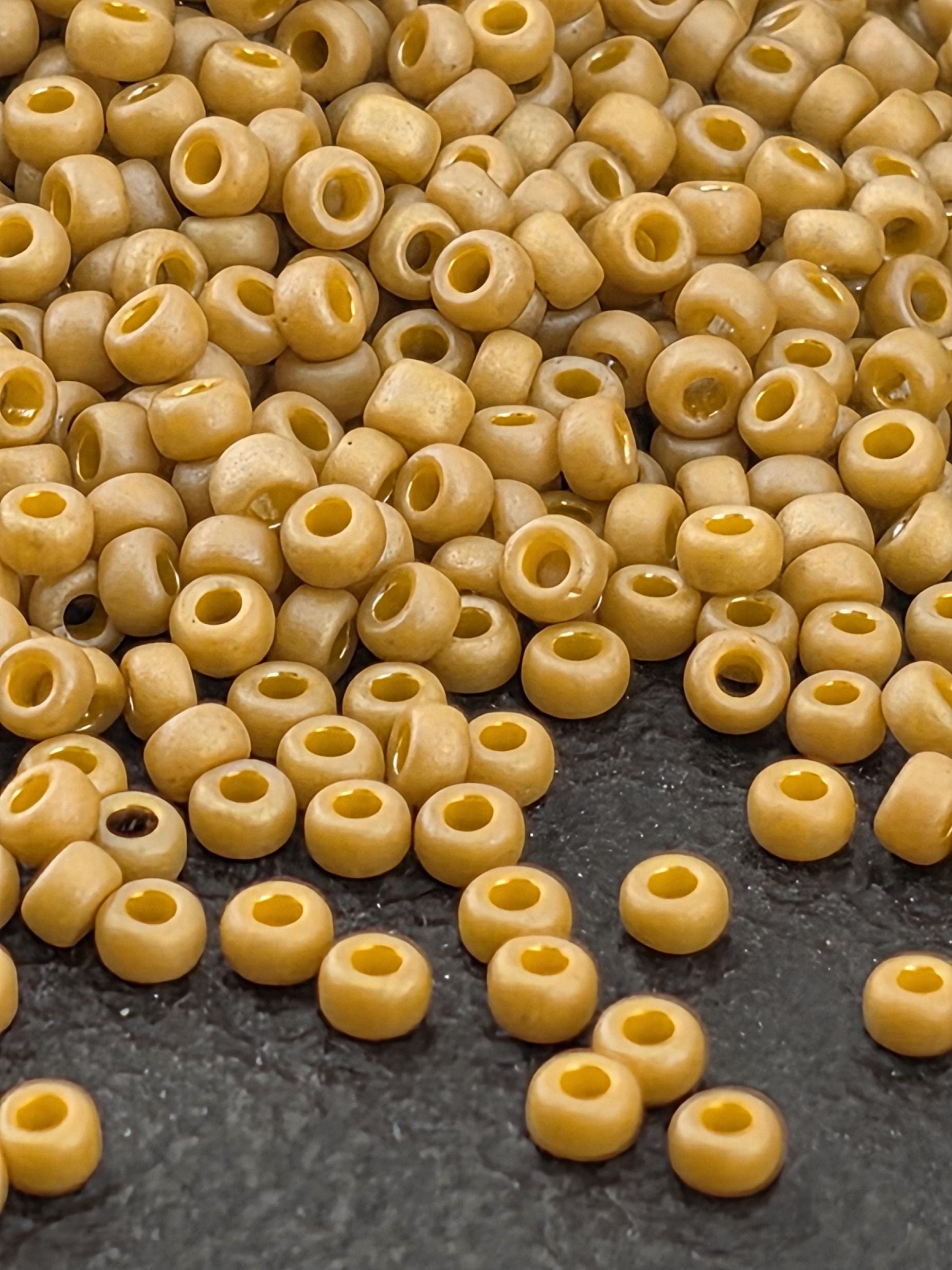 a close-up view of numerous small, round beads scattered on a dark surface.