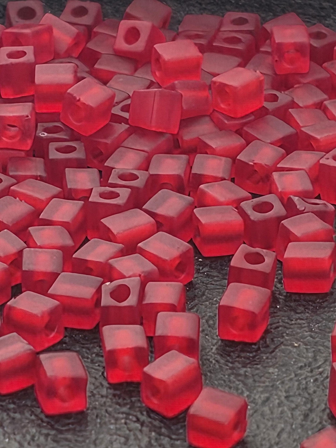 numerous red, square-shaped objects scattered across a surface, creating a visually striking and vibrant scene.