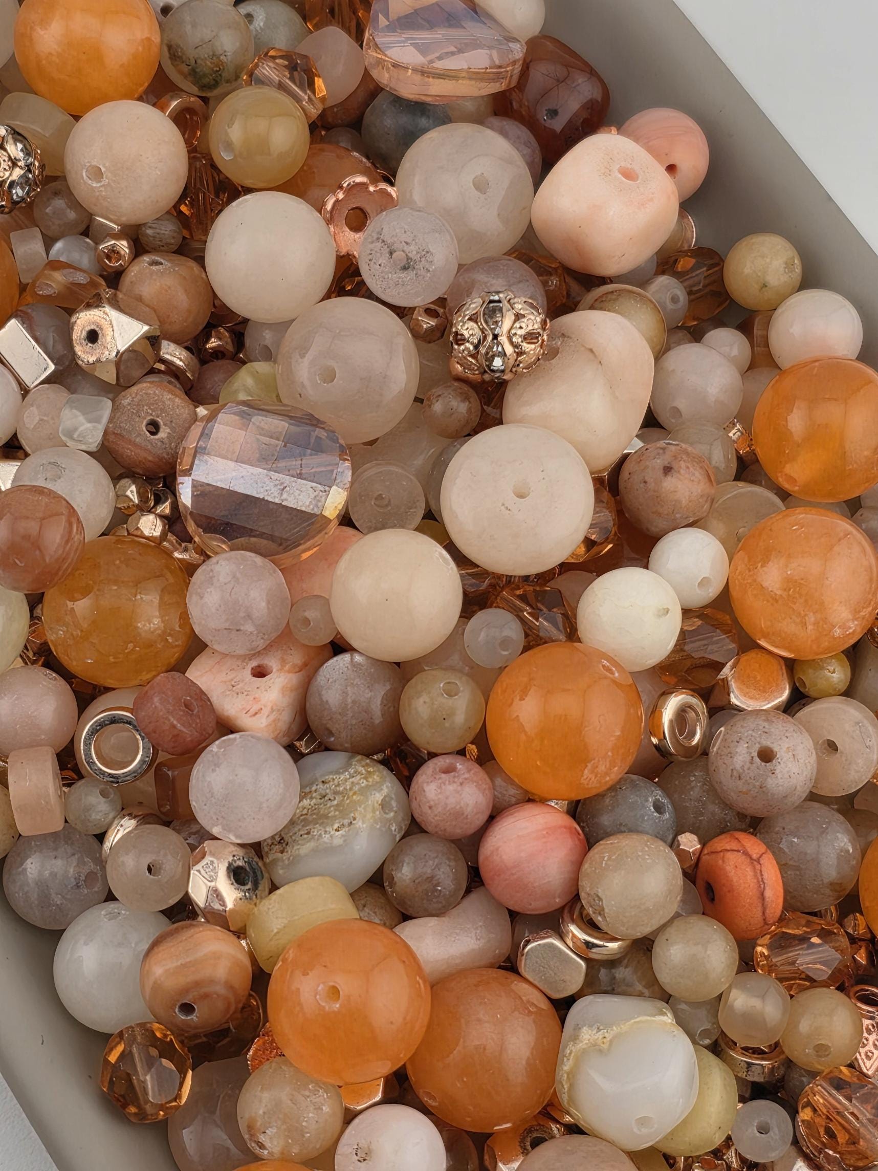 a variety of beads and beads in different shapes and sizes, including clear, white, and multicolored beads.