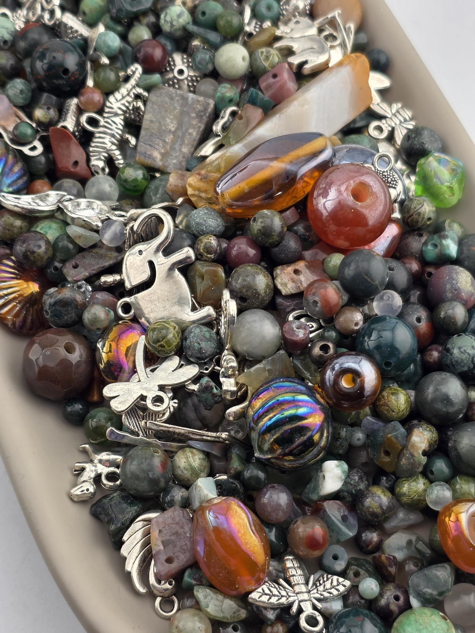 The image is a collection of various beads, charms, and other decorative items, including glass beads, metal charms, and other colorful elements, all arranged together in a visually appealing manner.