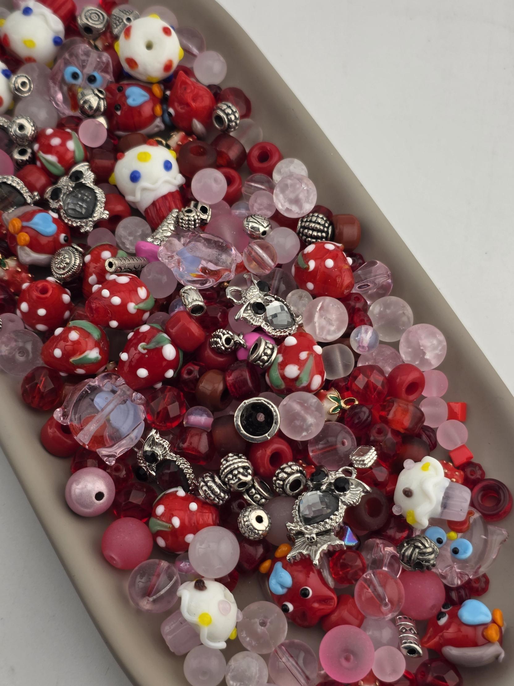 A collection of colorful beads, charms, and glass beads arranged on a surface.