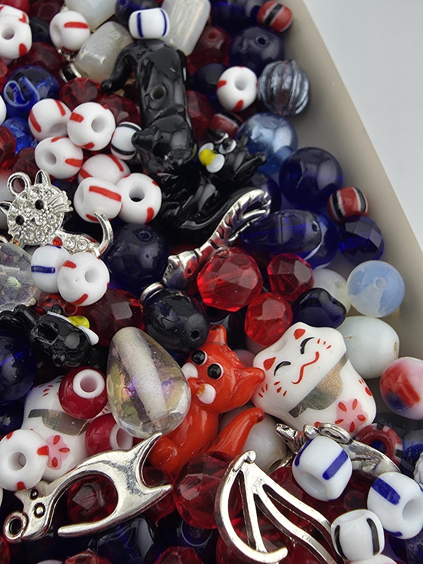 A colorful assortment of beads, charms, and other decorative items are scattered across the image.