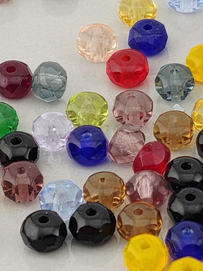 a variety of colorful glass beads scattered across a surface.