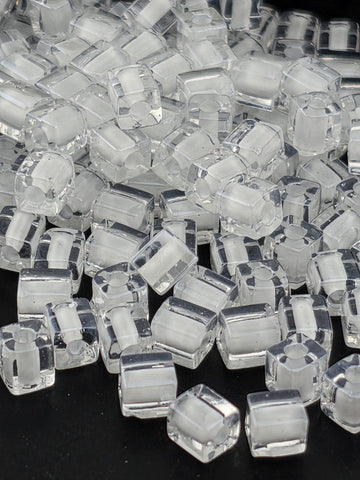a close-up view of numerous clear, transparent cubes or blocks of a material, possibly glass or plastic, arranged in a visually interesting manner.