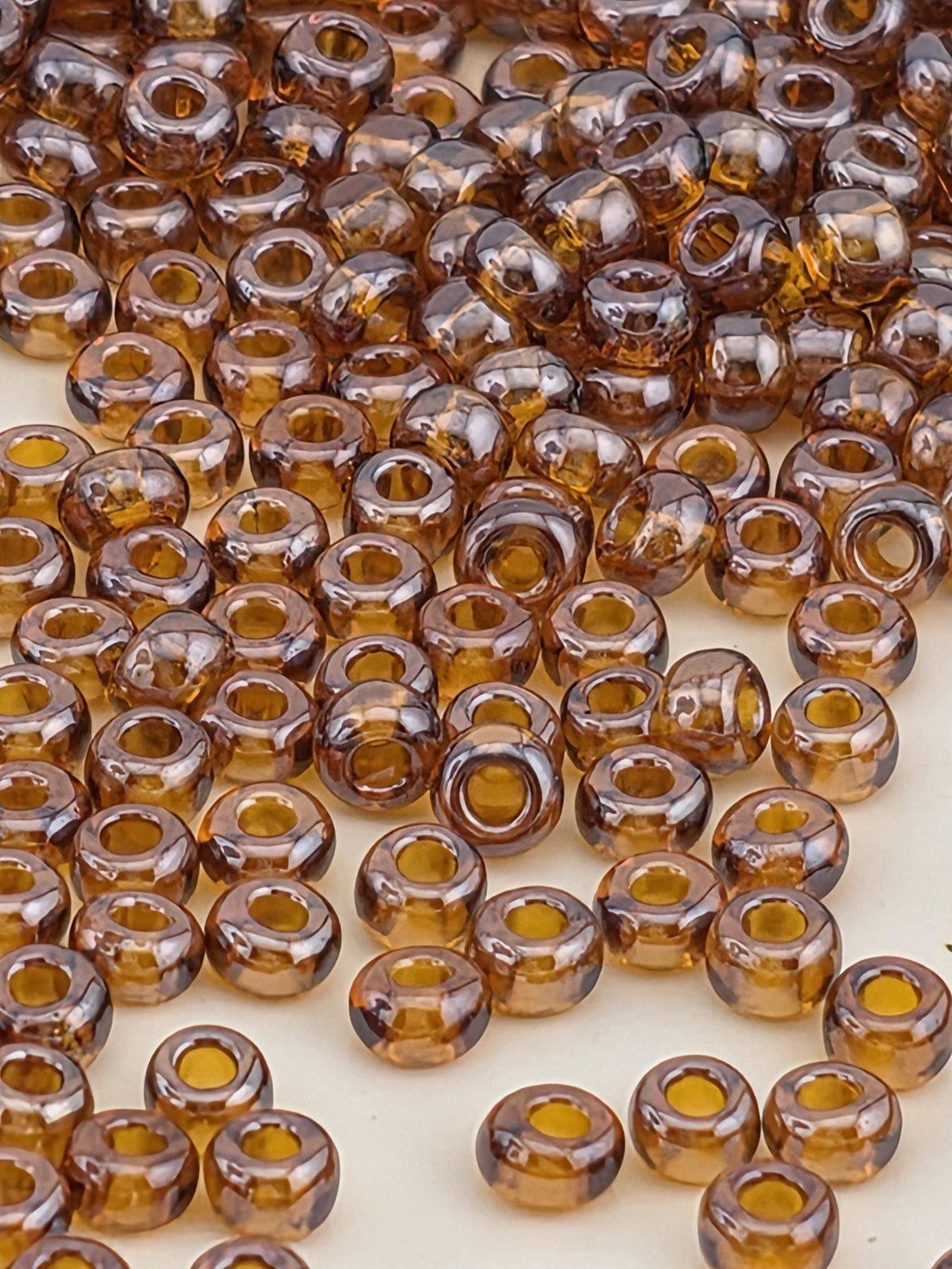 a close-up view of numerous brown glass beads scattered across a surface.