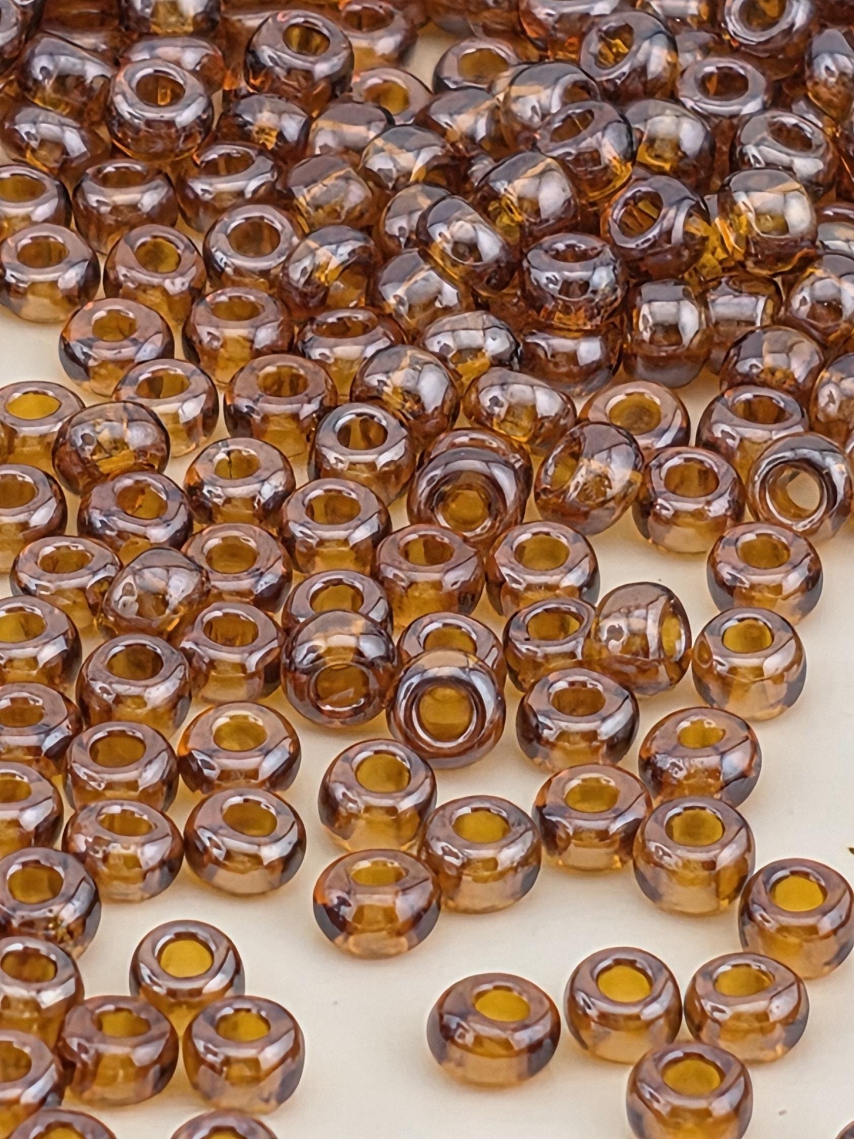 a close-up view of numerous brown glass beads scattered across a surface.