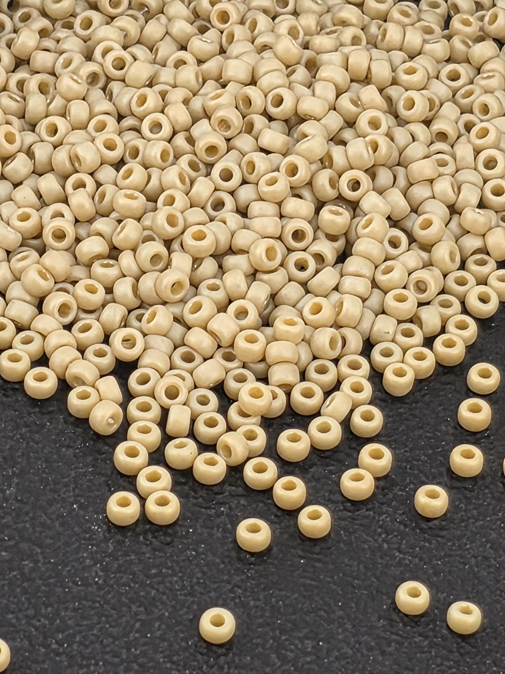 a large pile of small, round beads scattered on a dark surface.