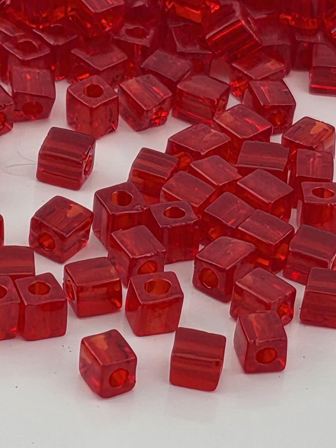 a collection of red, square-shaped objects scattered across a white background.