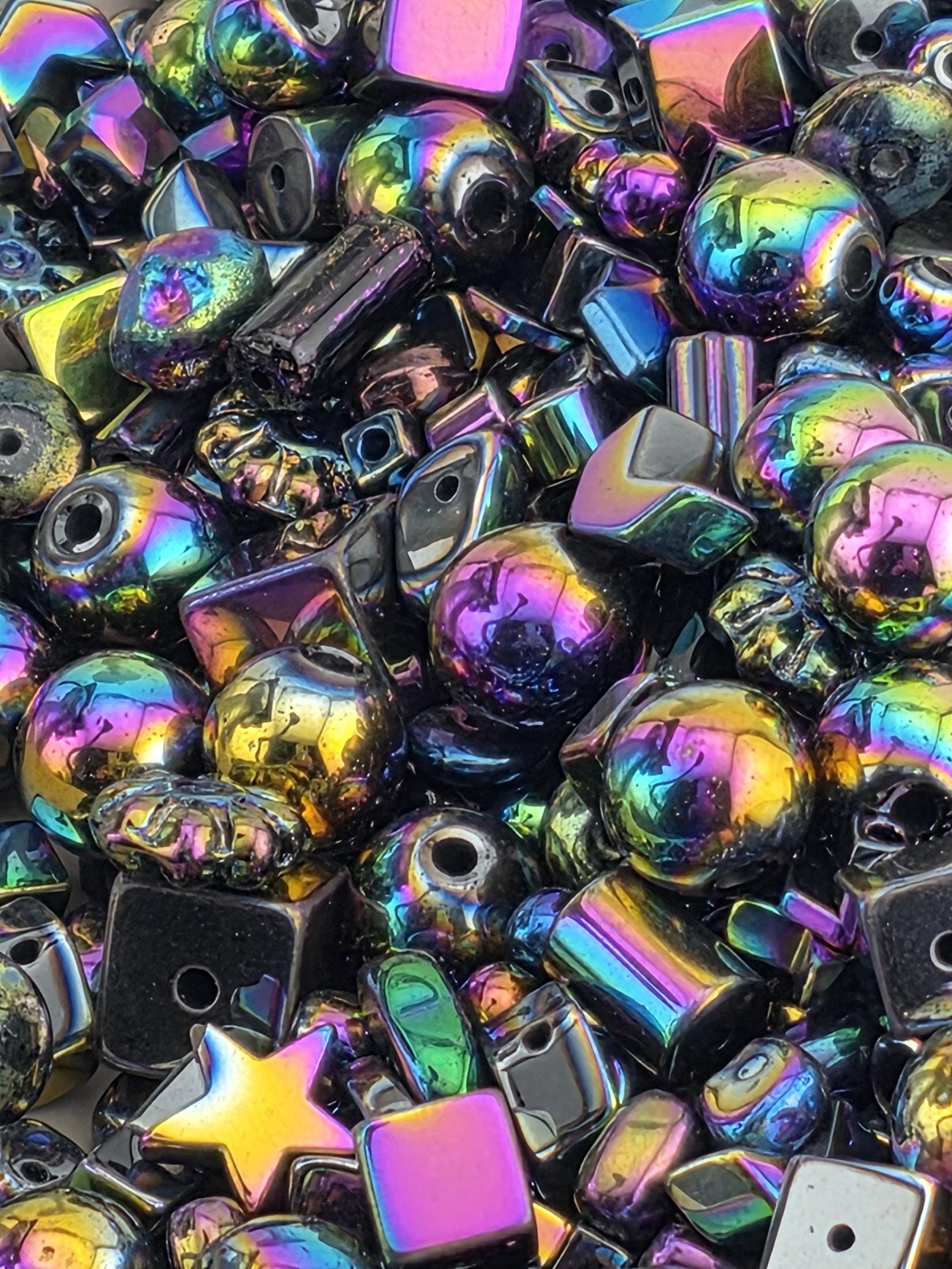 The image is a close-up of a collection of colorful glass beads and shapes, including various sizes and shapes, arranged in a visually striking manner.