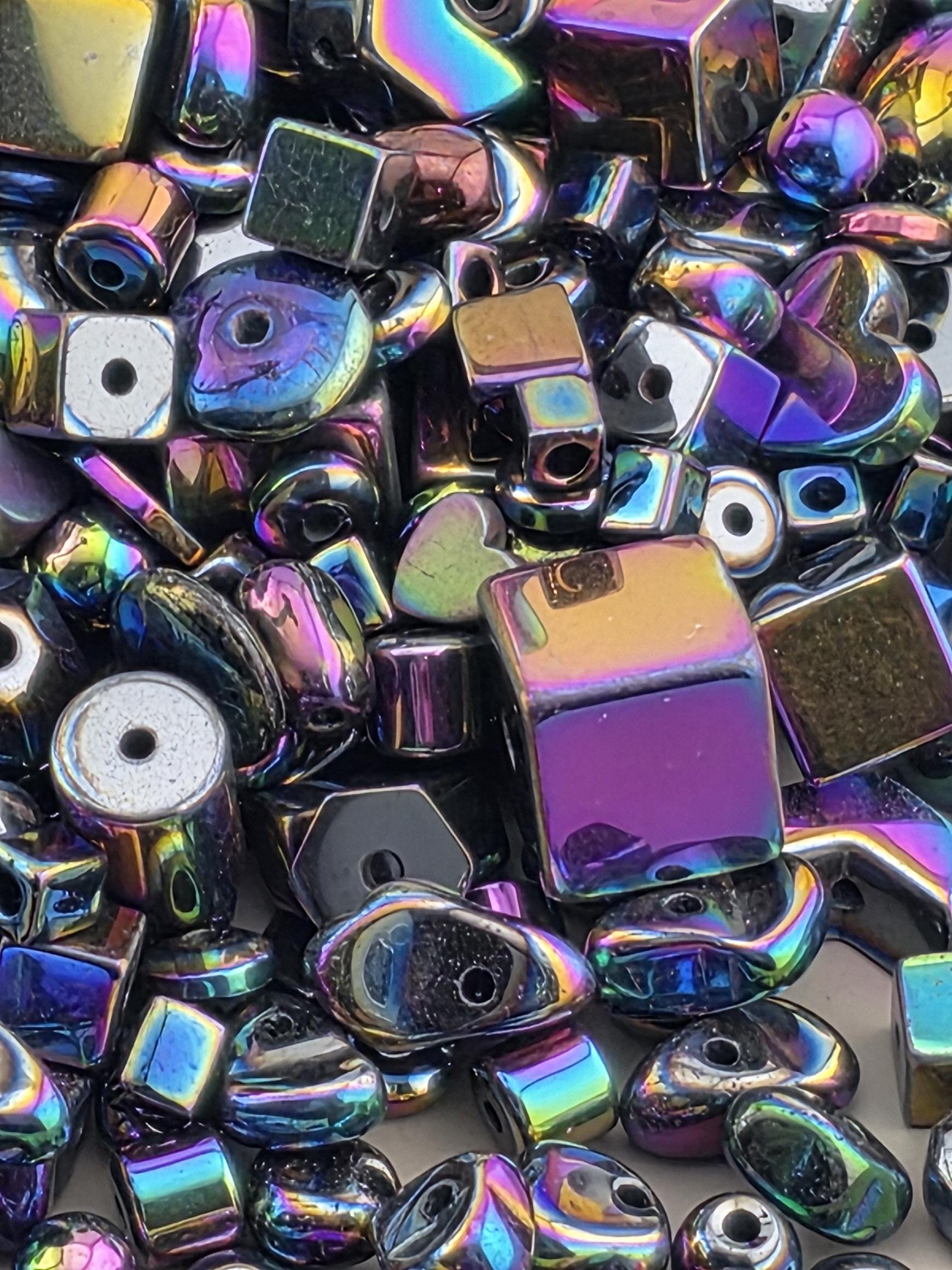 The image is a close-up of a collection of colorful, shiny beads and beads, with a variety of shapes and sizes.