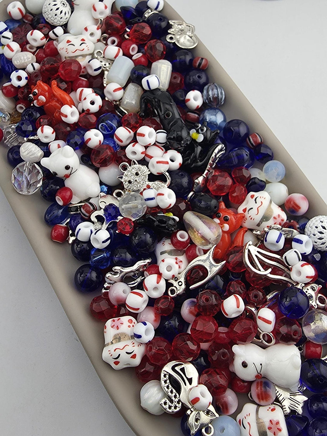 A collection of various colorful beads, charms, and trinkets arranged in a visually appealing manner.