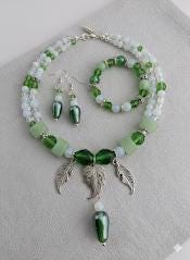 A collection of various colorful beads, gemstones, and metal charms arranged on a surface.