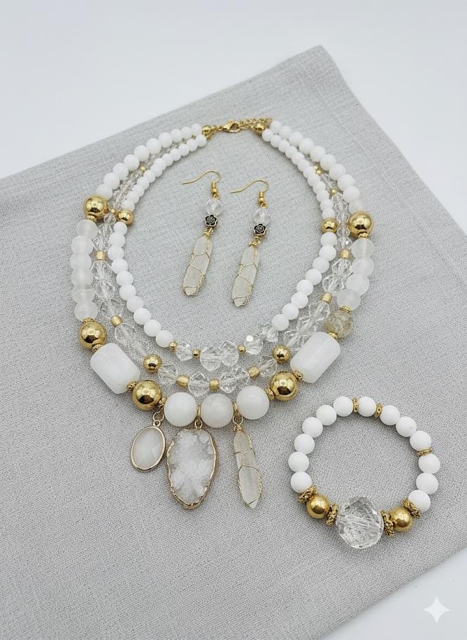 The image is a collection of various white and clear beads, charms, and other decorative items arranged on a surface.