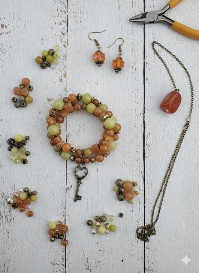 A collection of various beads, gemstones, and metal objects, including a key, arranged in a visually appealing manner.